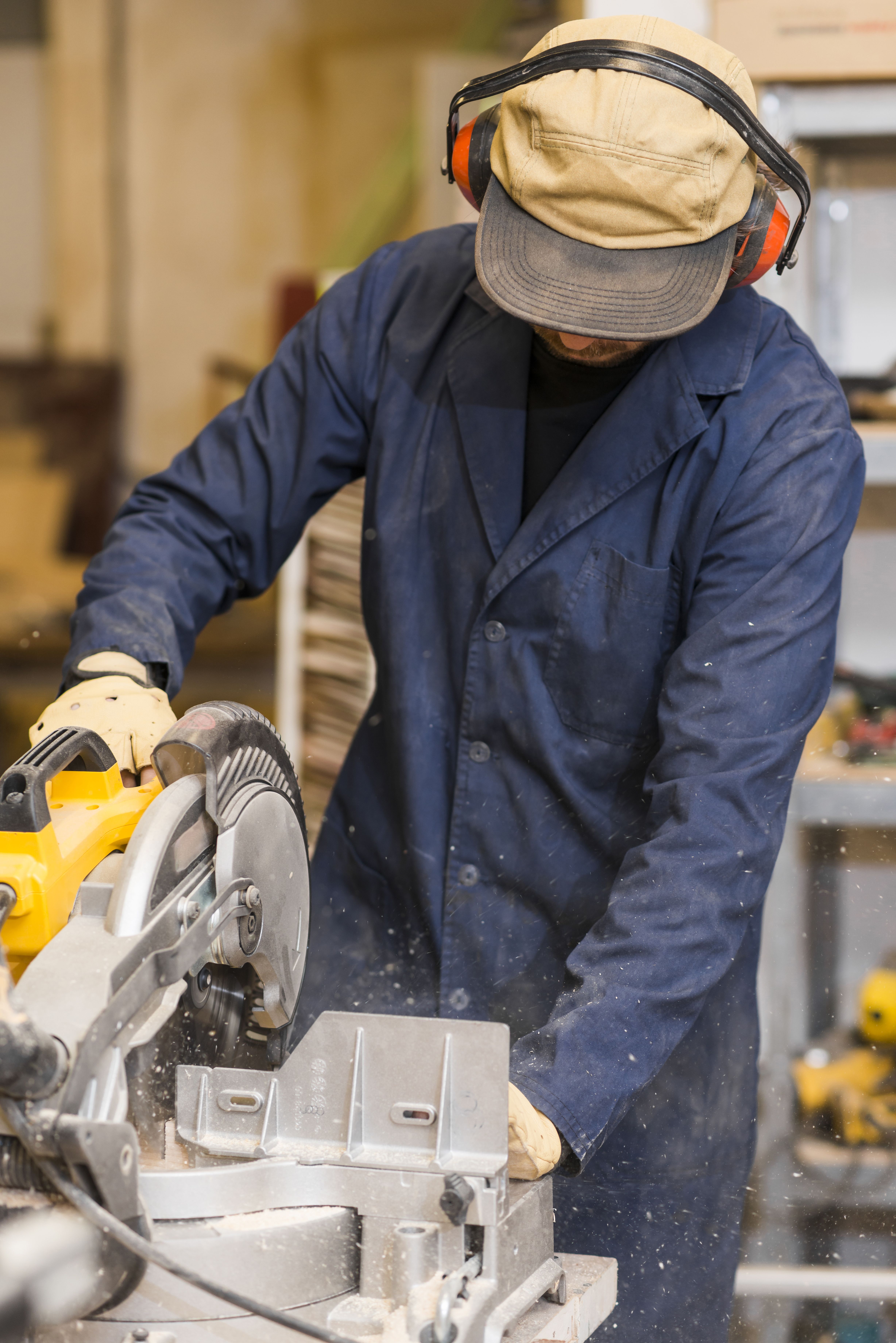 male carpenter using some power tools his work woodshop